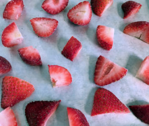 Freeze strawberry pieces on wax paper on cookie sheet before bagging