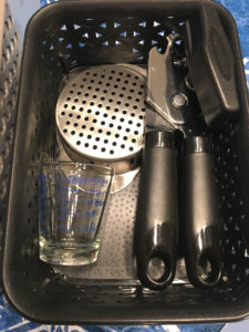 can opener, can drainer and shot glass measuring cup