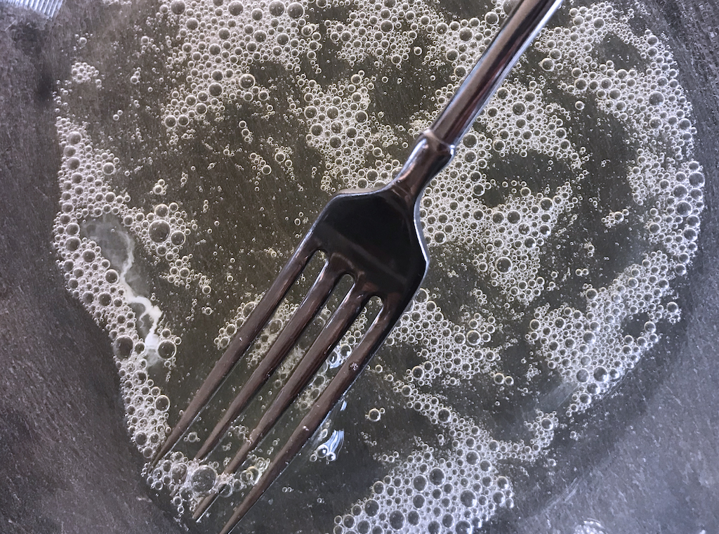 whisking egg white with fork for nut mix