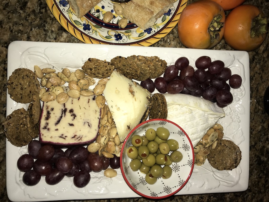 Cheese, crackers, fruit and seeds charcuterie