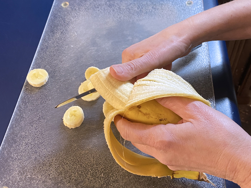 cutting fresh banana slices