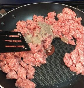Turning ground beef as it browns