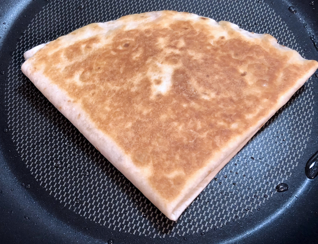 A golden brown quesadilla packet