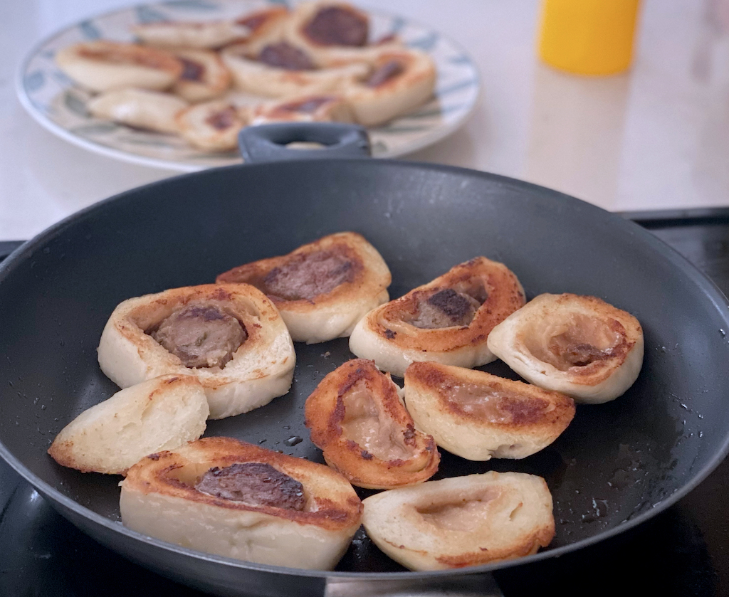 Bao slices toasting in a skillet