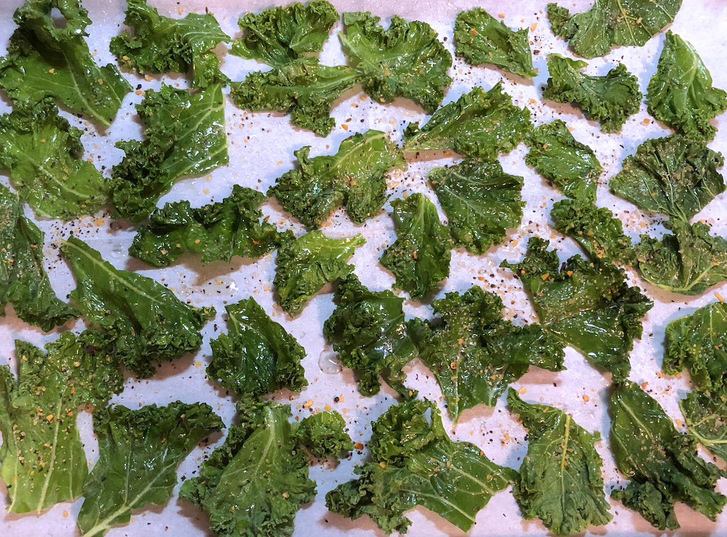 Kale torn into chips ready for baking