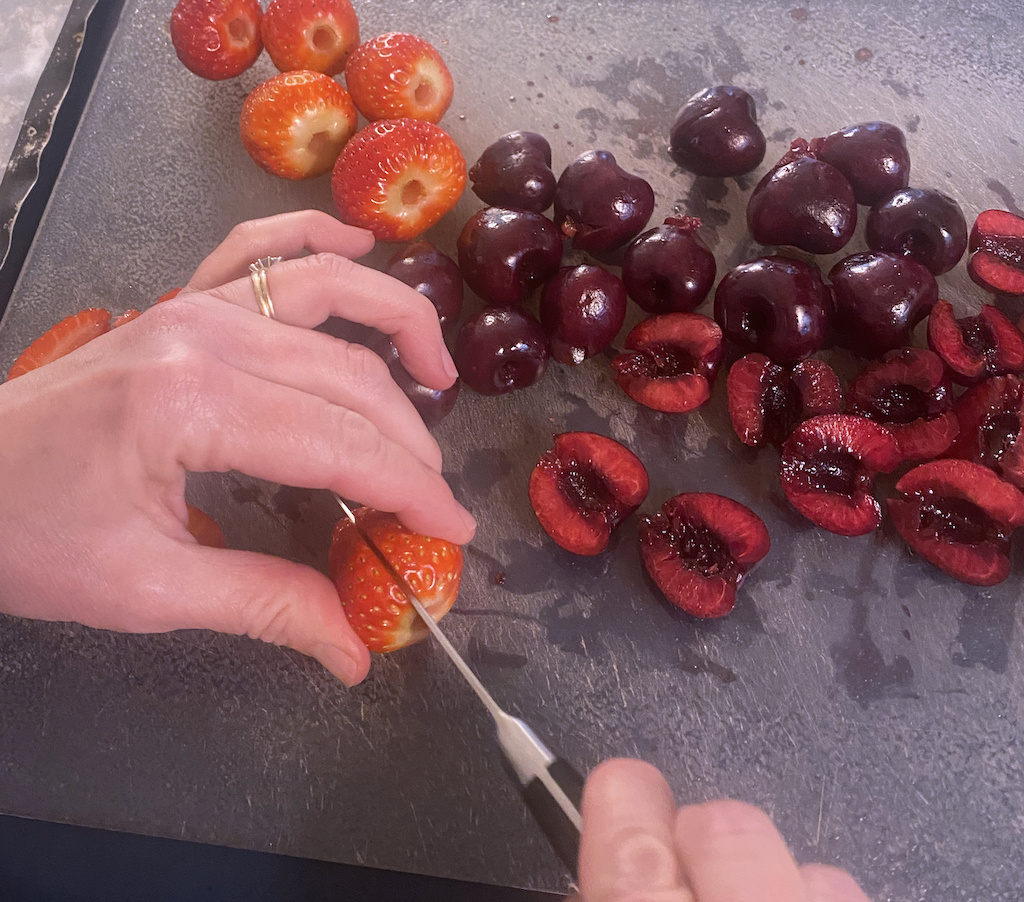 After de-stemming or pitting, slice your fruit as you wish to freeze or decorate a cake